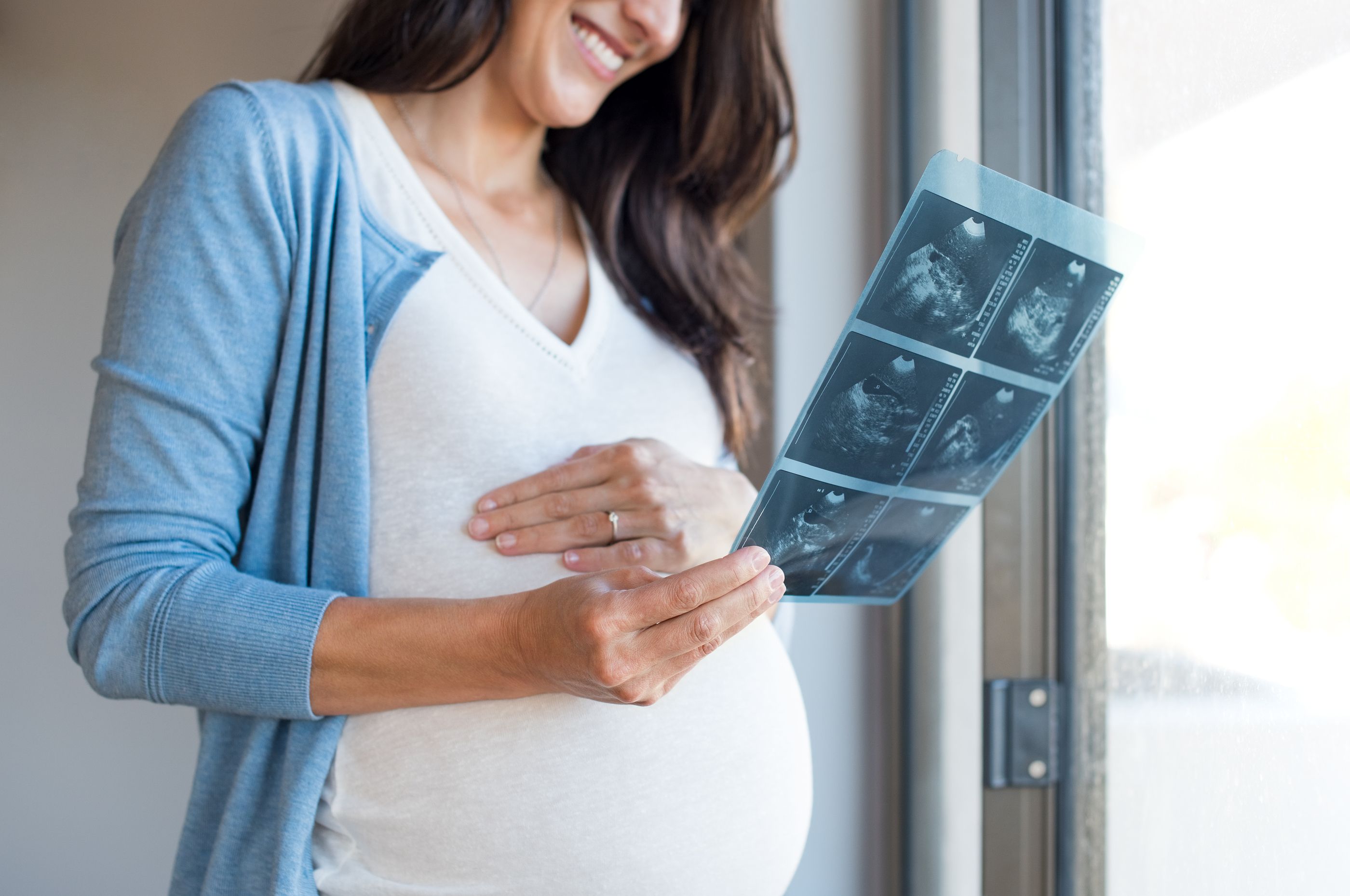 Pregnant Woman Holding Ultrasound Report At Home Mature Lovely Centro Diagnostico Granada